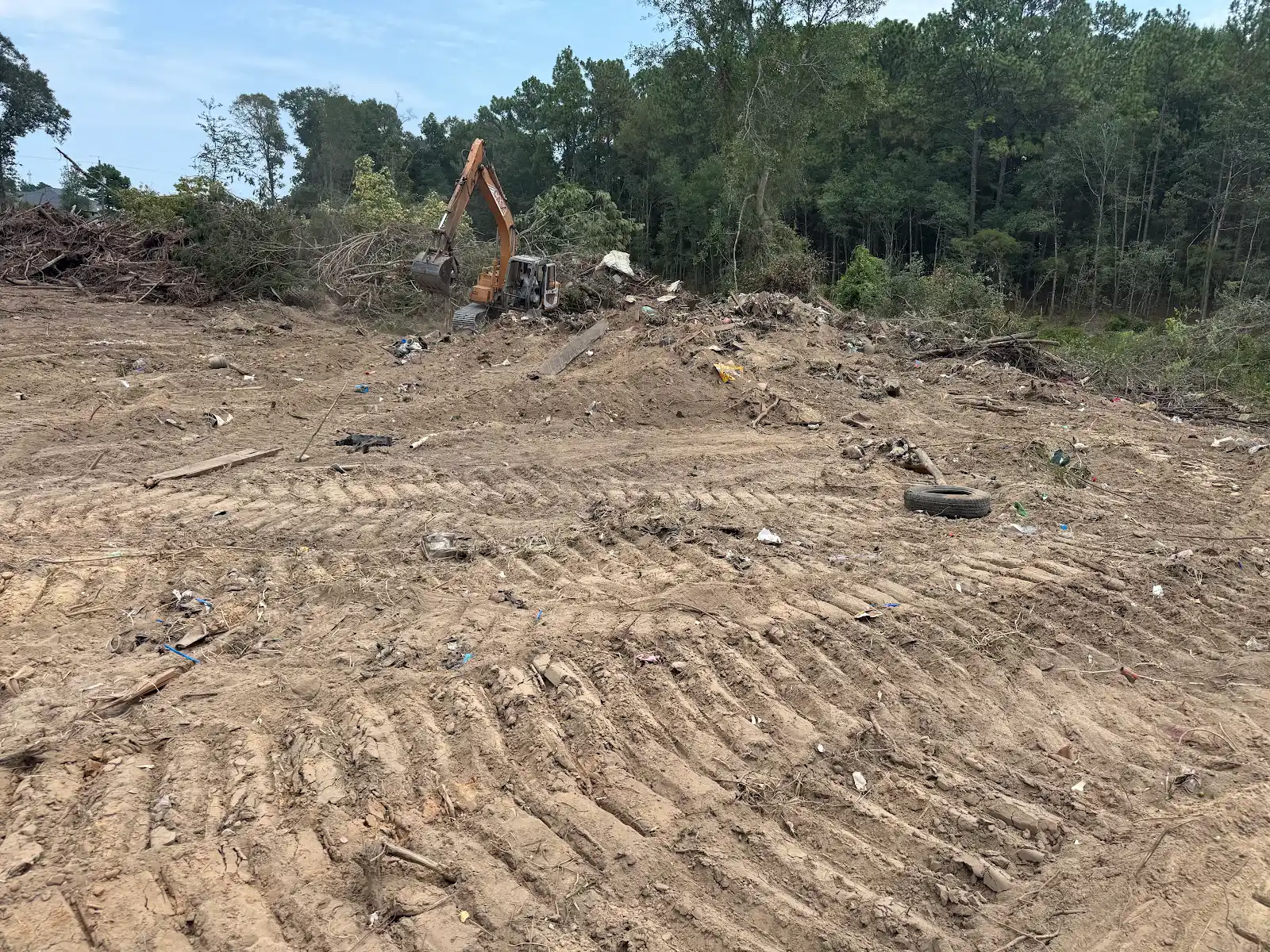 Excavator working at a land clearing site