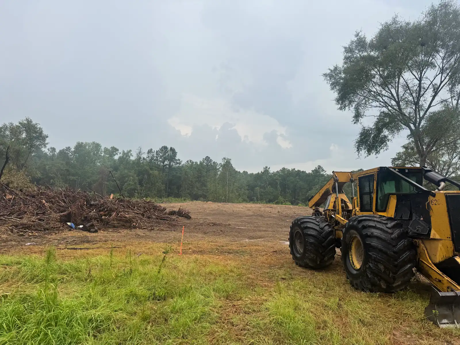 Heavy equipment beside a cleared worksite